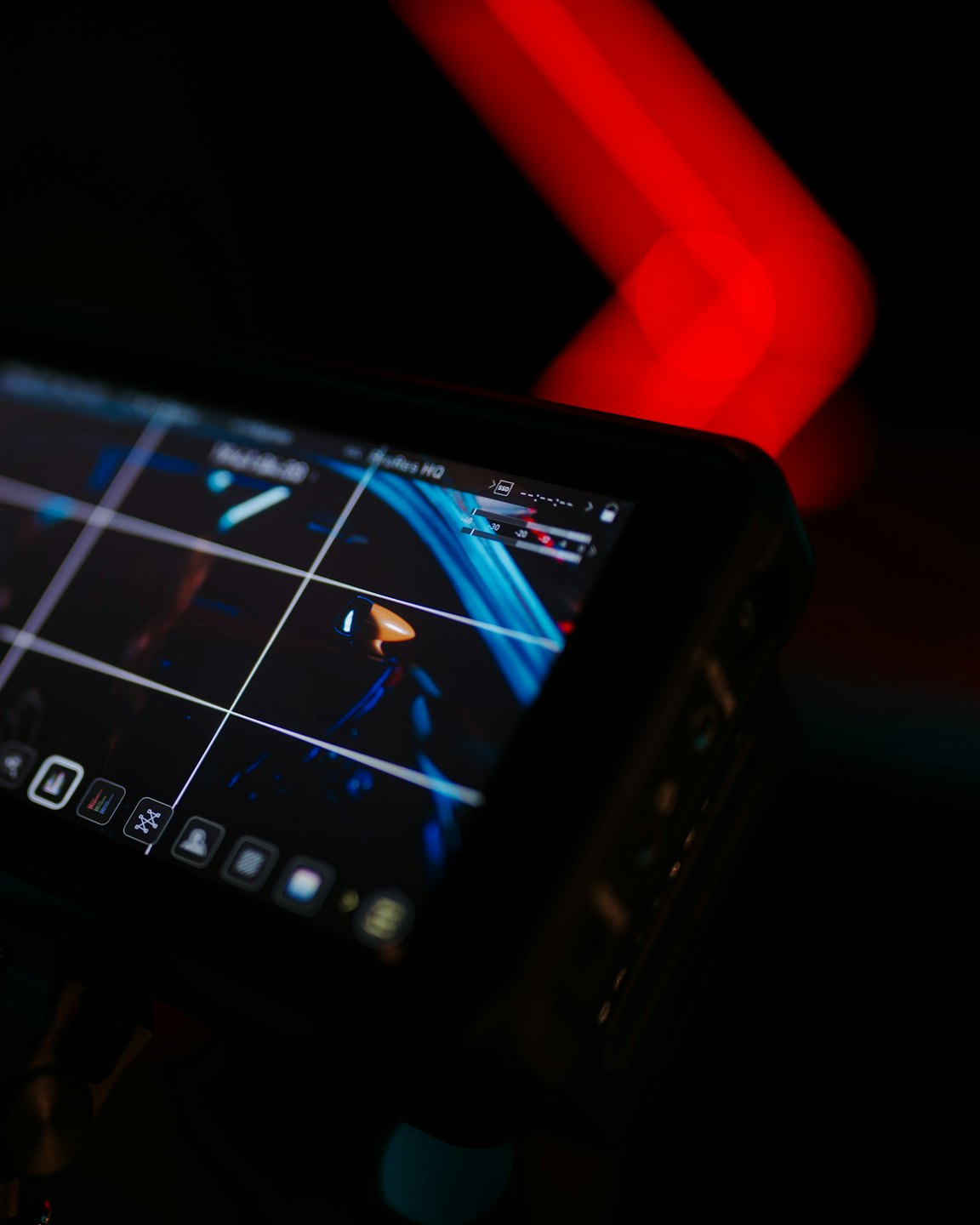 Computer monitor displays a blue and white interface with grid lines and icons.